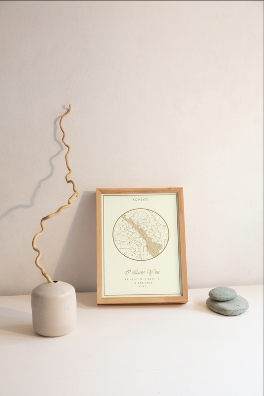 Framed star map on a table with a vase and stones